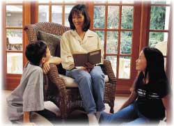 mother reading to two children